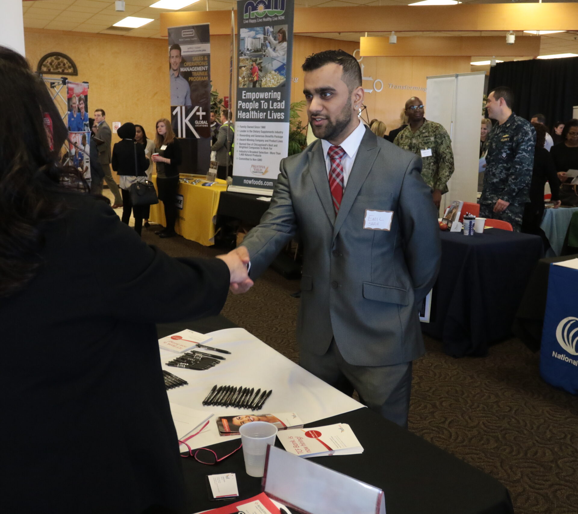 Student at career fair shaking hands with with employer