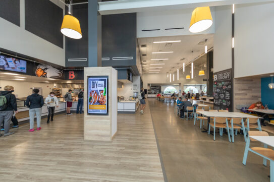 Photo of Benny's cafeteria from the entrance, tables and the food line are visible; dining services