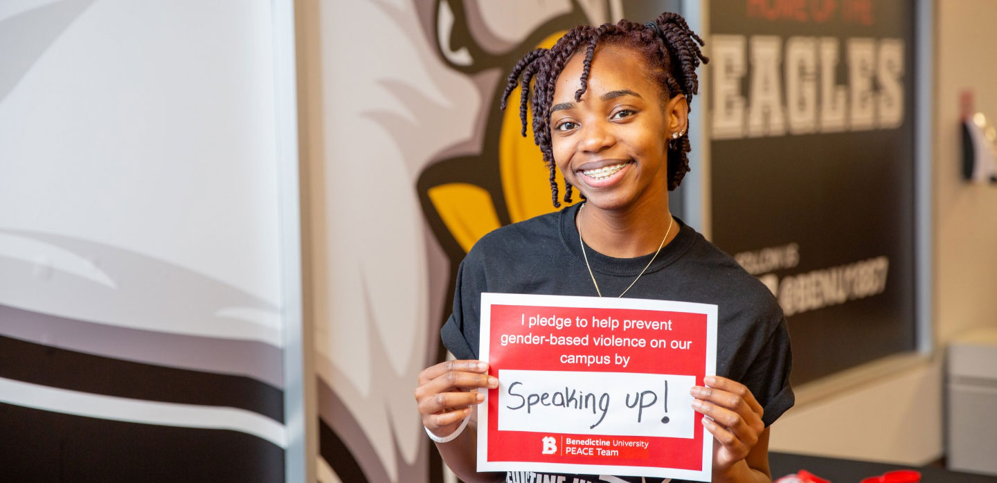 African American female holding "speak up" sign, PEACE Team