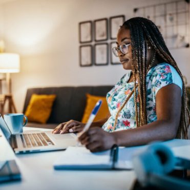 African American female student studying from home on laptop