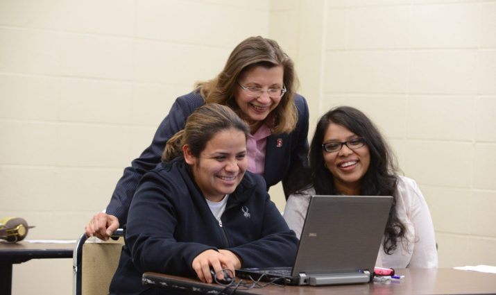 female, adult students, on laptop with Professor