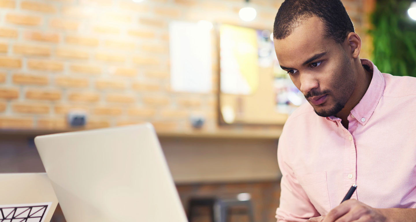 male student with intense look at computer