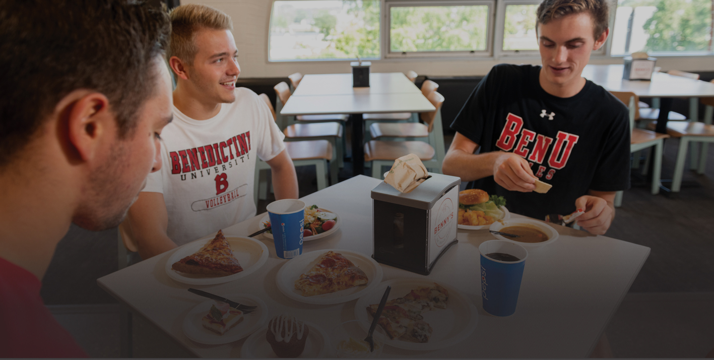 male student eating at Benny's, the student cafeteria on Lisle's campus
