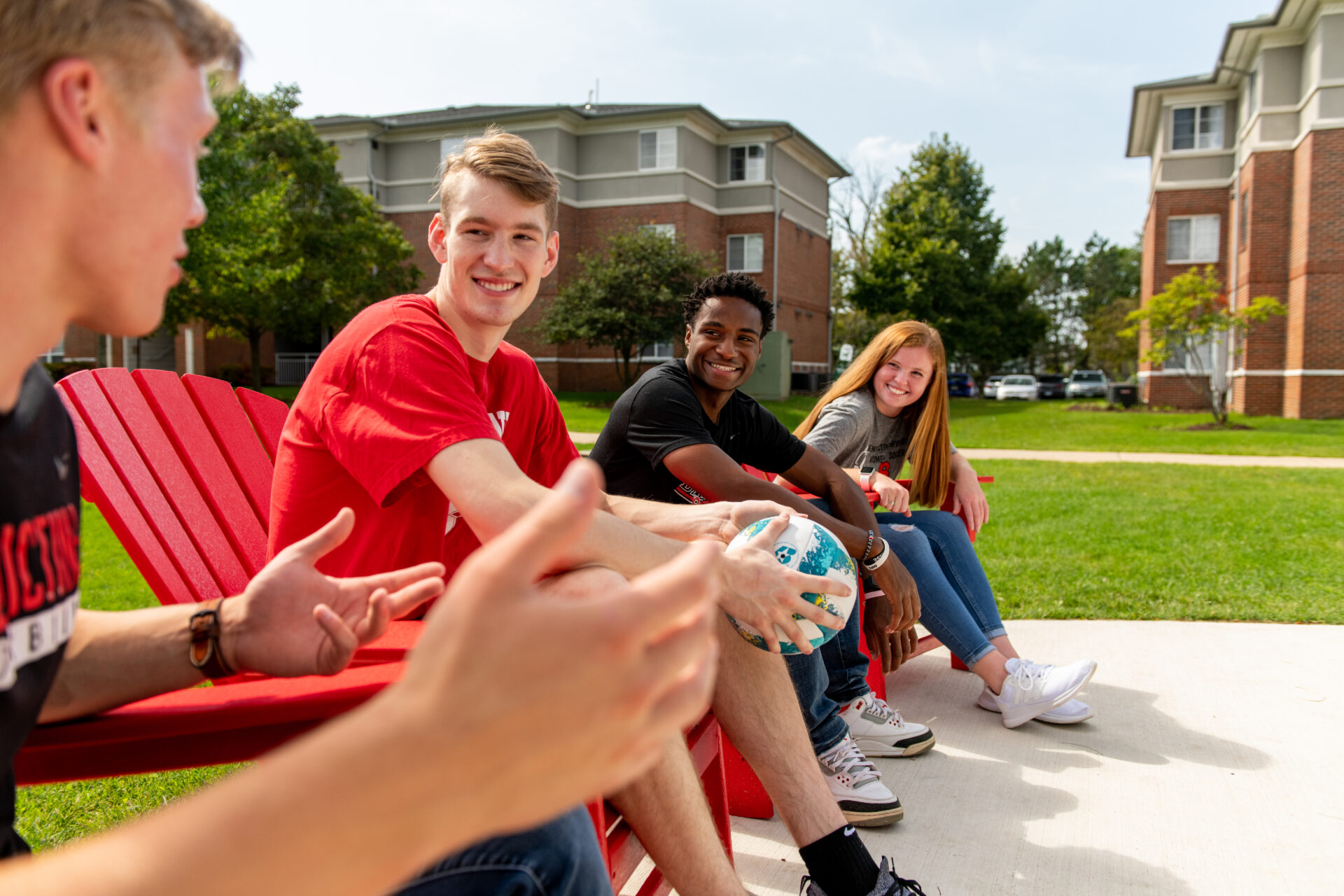 Students hanging out in the apartment quad