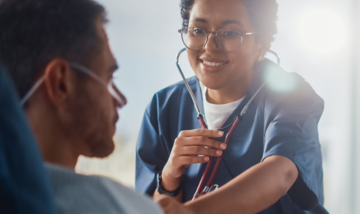 female pre-professional student with stethoscope examining patient; pre-medicine