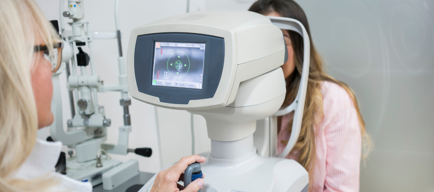 optometrist using equipment to look into patients eyes; pre-optometry
