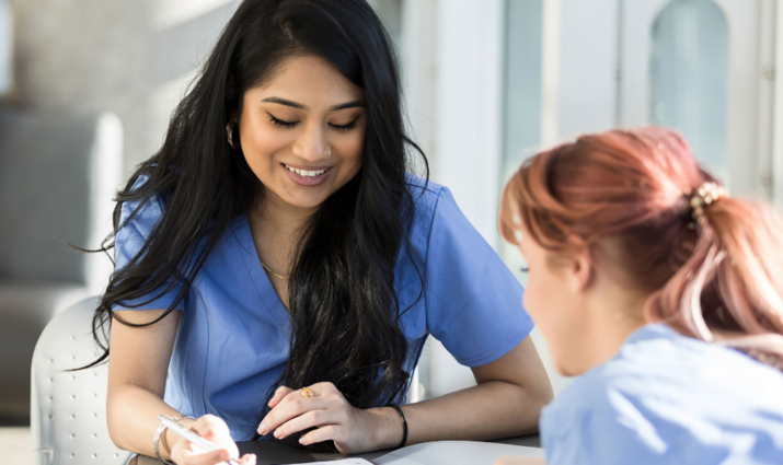 Female pre-professional student studying with another student