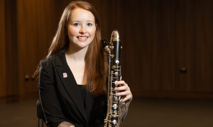 Female student posing with her clarinet, music, band