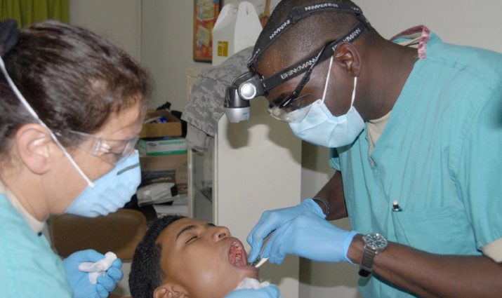 dentist with assistant and patient