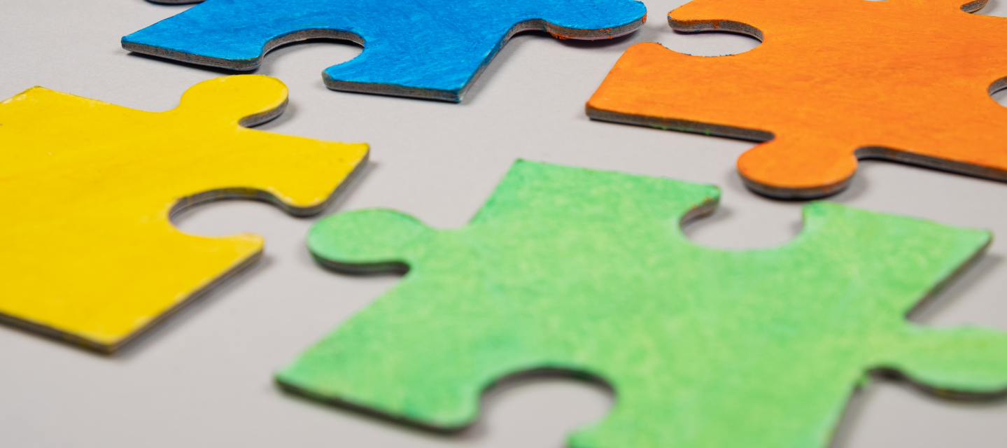 four colorful puzzle pieces sitting next to each other; special education