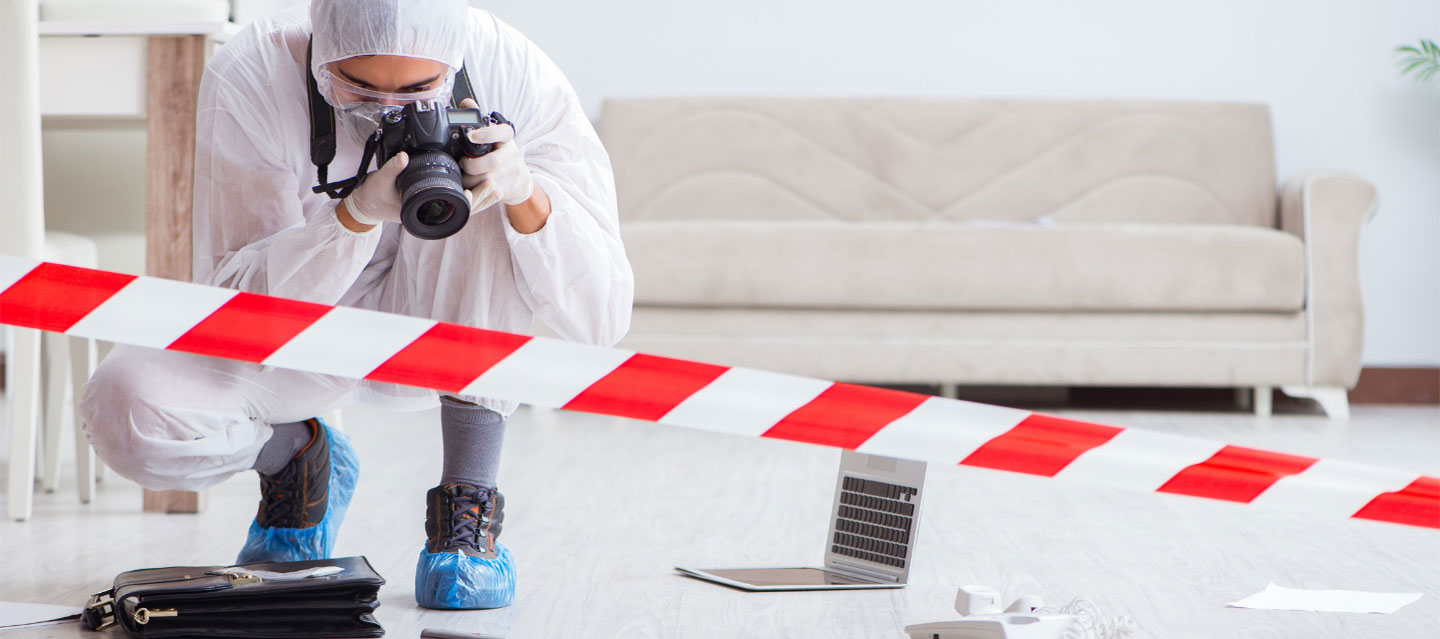 photographer in hazmat suit photographing crime scene; criminology