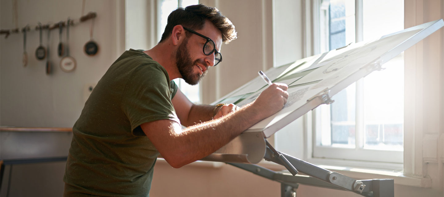 male art student drawing on canvas; studio art