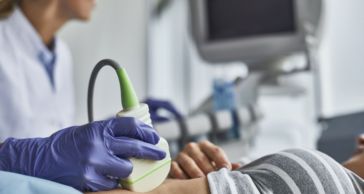 hand holding a wand doing diagnostic medical sonography work