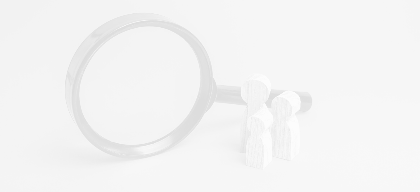magnifying glass with three small wooden people-shaped wooden figures by the handle, image has a white overlay; sociology