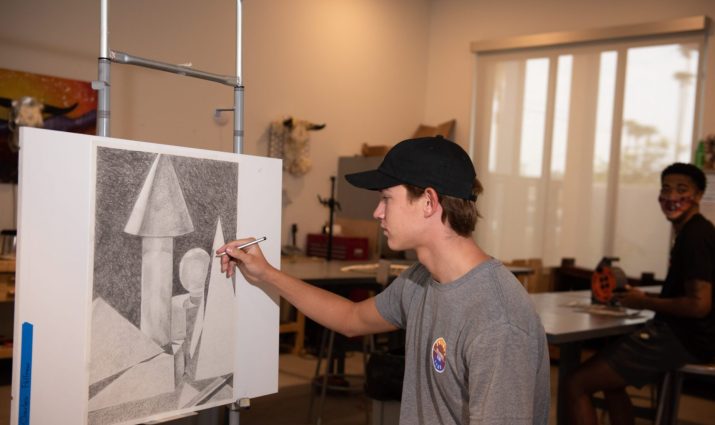 Mesa student in art class, easel, drawing