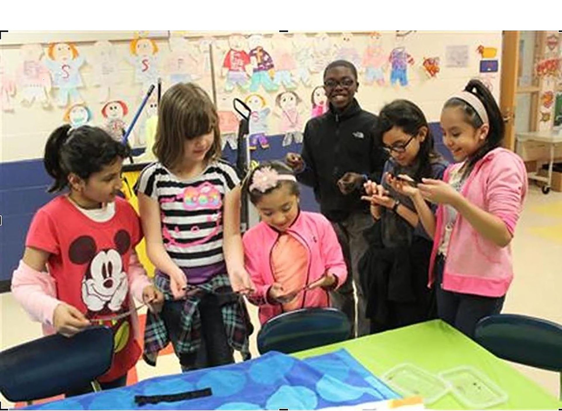 Group of elementary school students looking at science experiments