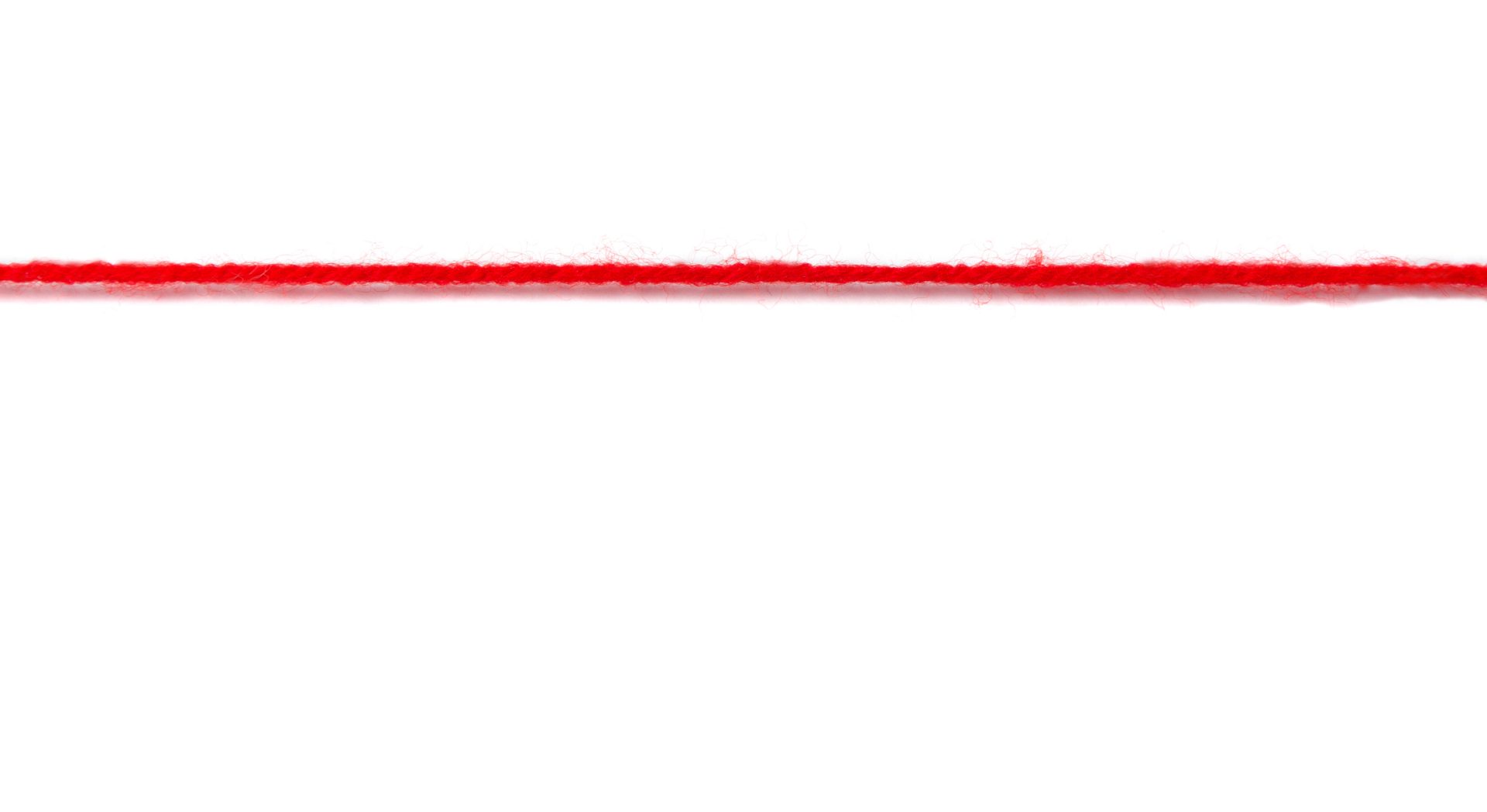 Thick red woolen thread on a white background. nerves to the limit concept