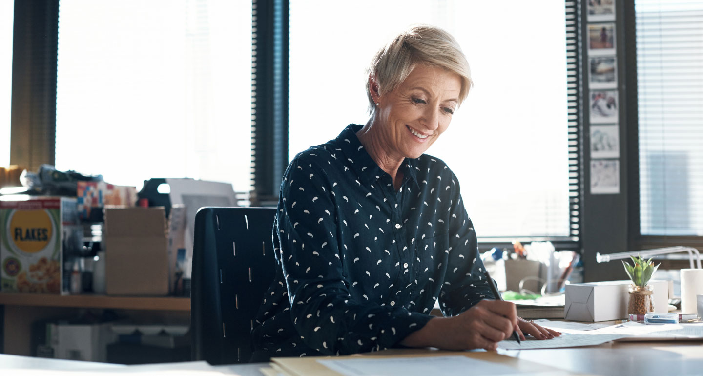 Professional woman working at her office desk; Grants office