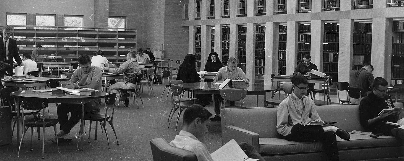 historic photo of students studying at library tables in Scholl Hall; archives