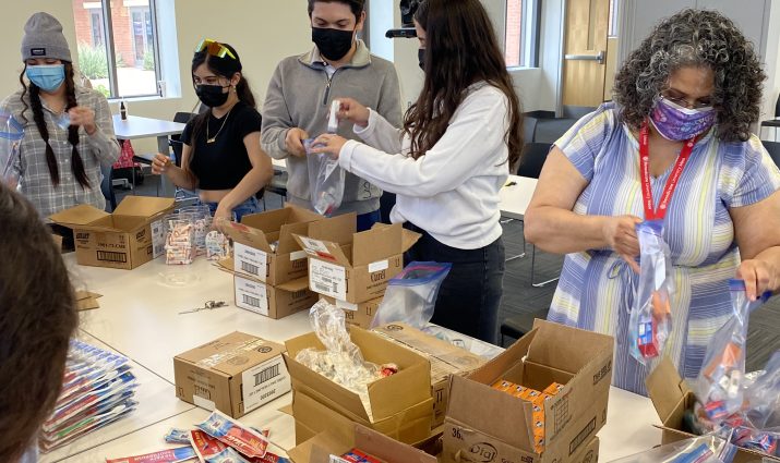 group of students gathered to put together care boxes with Mesa's "B" Involved program