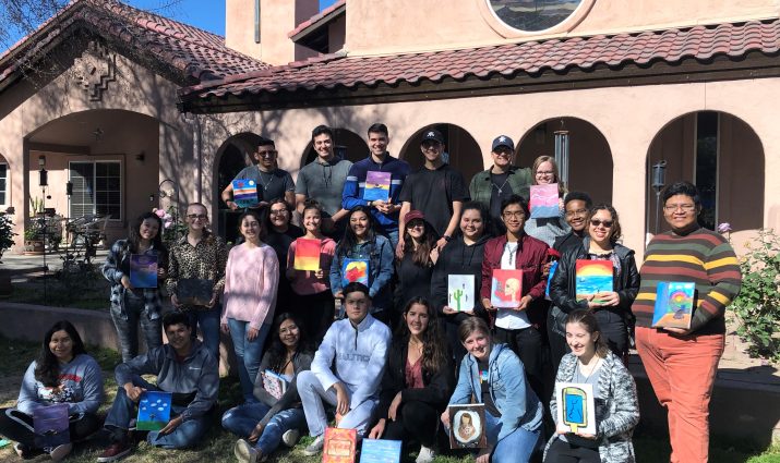 Mesa's student ministry group with artwork that they created at a retreat