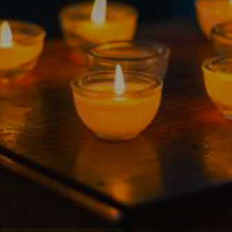 prayer candles lit on a table - campus ministry prayer requests