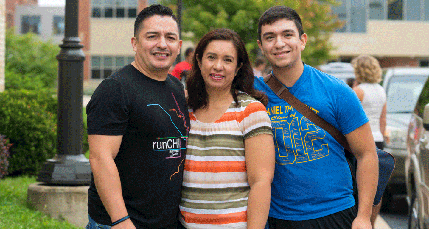 male student with his parents during move in