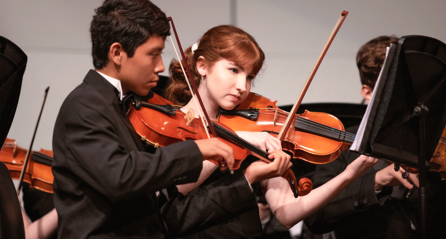 music scholarships available. Male and female student playing violin