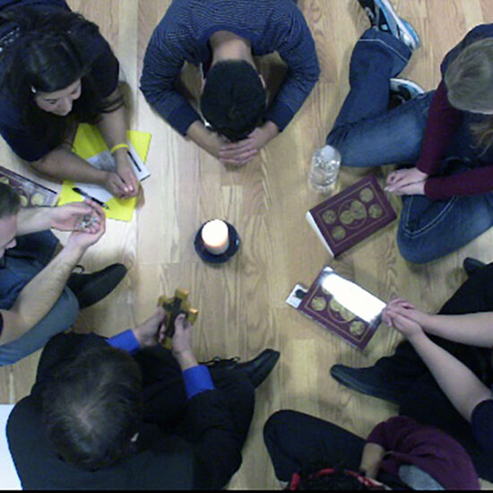 students in a circle praying