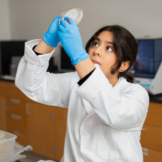 female lab student holding up specimen