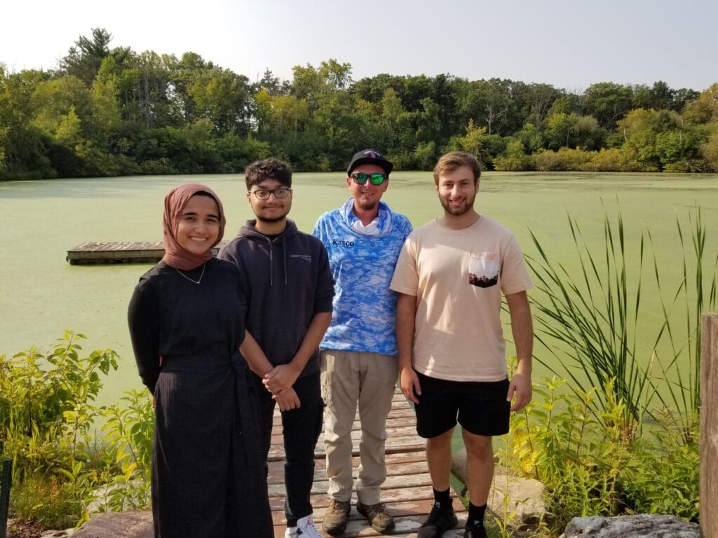 photo by Lake St. Benedict. Also standing with the students near Lake St. Benedict is Chris Cartwright of Kasco Marine, who has been kindly assisting in testing of Kasco Marine aeration and mixing equipment at no cost to the University.