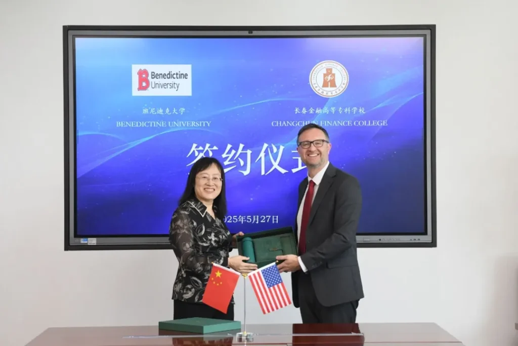 BenU President Joseph J. Foty, PhD, shaking hands with leadership from Changchun Financial College