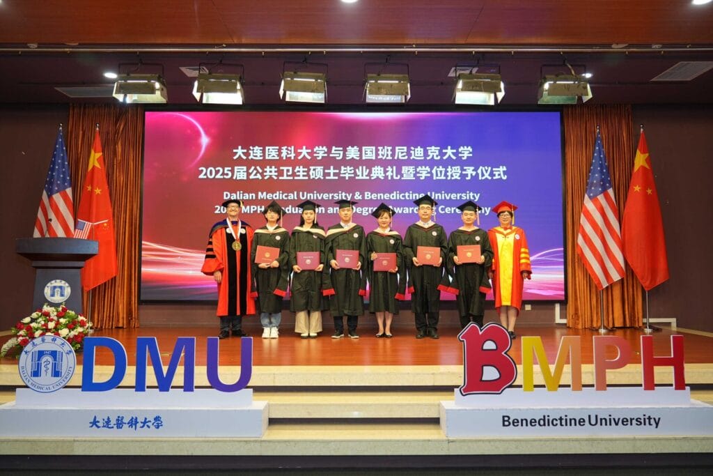 BenU President Joseph J. Foy, PhD, pictured with graduates of Dalian Medical University