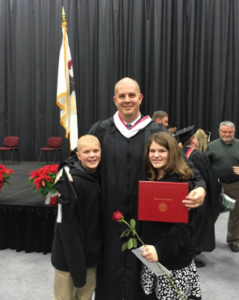 BenU alum Kirk Grummer with his children at graduation