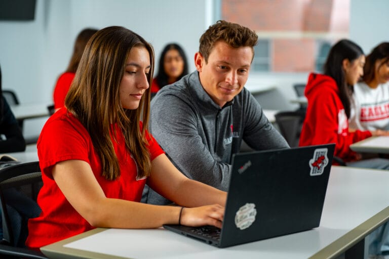 Two students learning with a computer