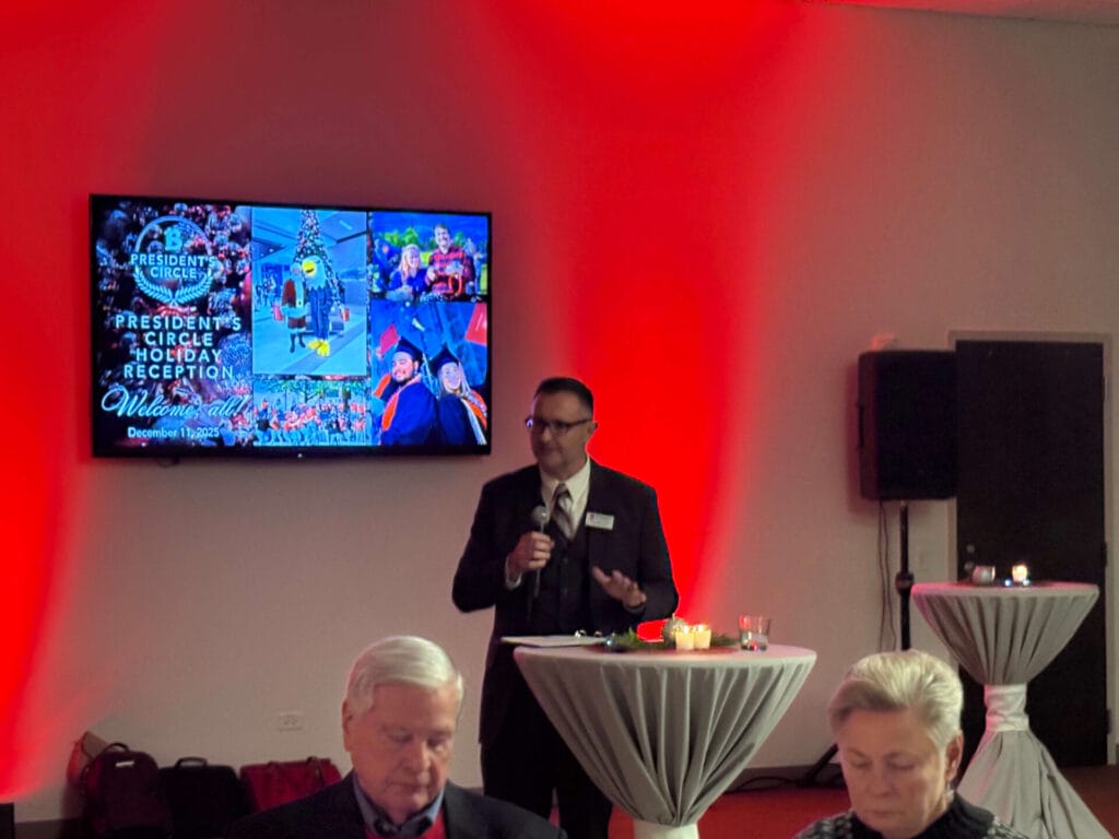 photo of guests and dr. joseph j. foy at benedictine university for the president's circle holiday reception. multiple individuals were in attendance for this gathering