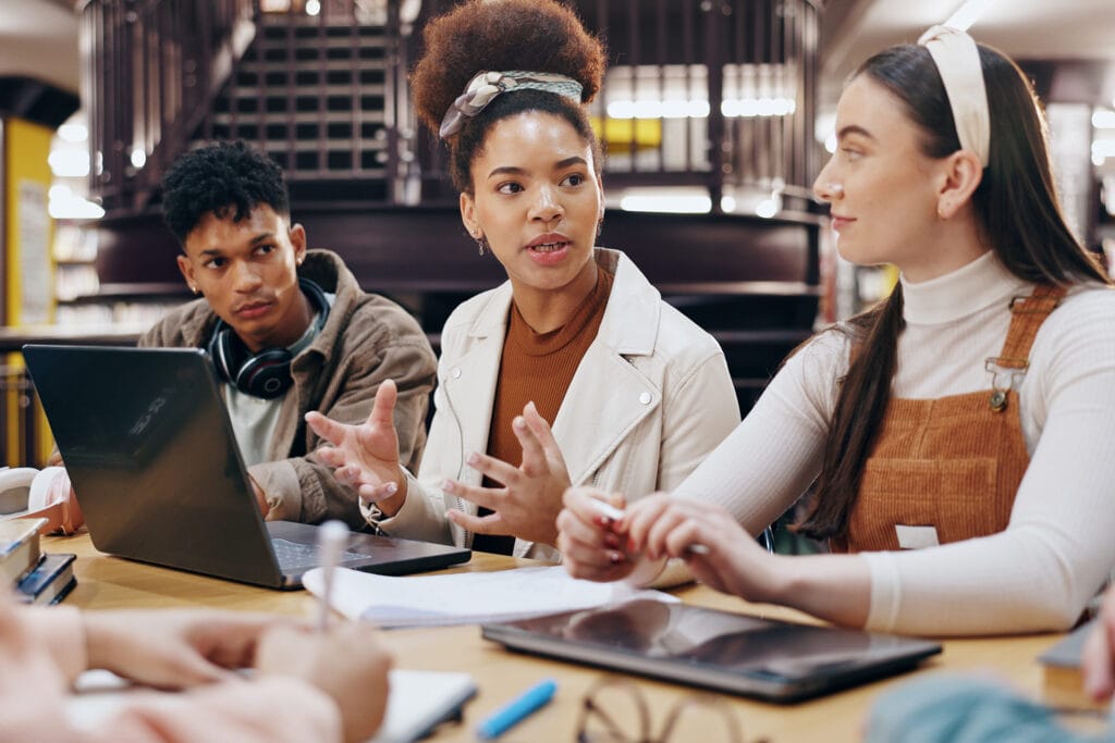 Image of masters university students discussing a project
