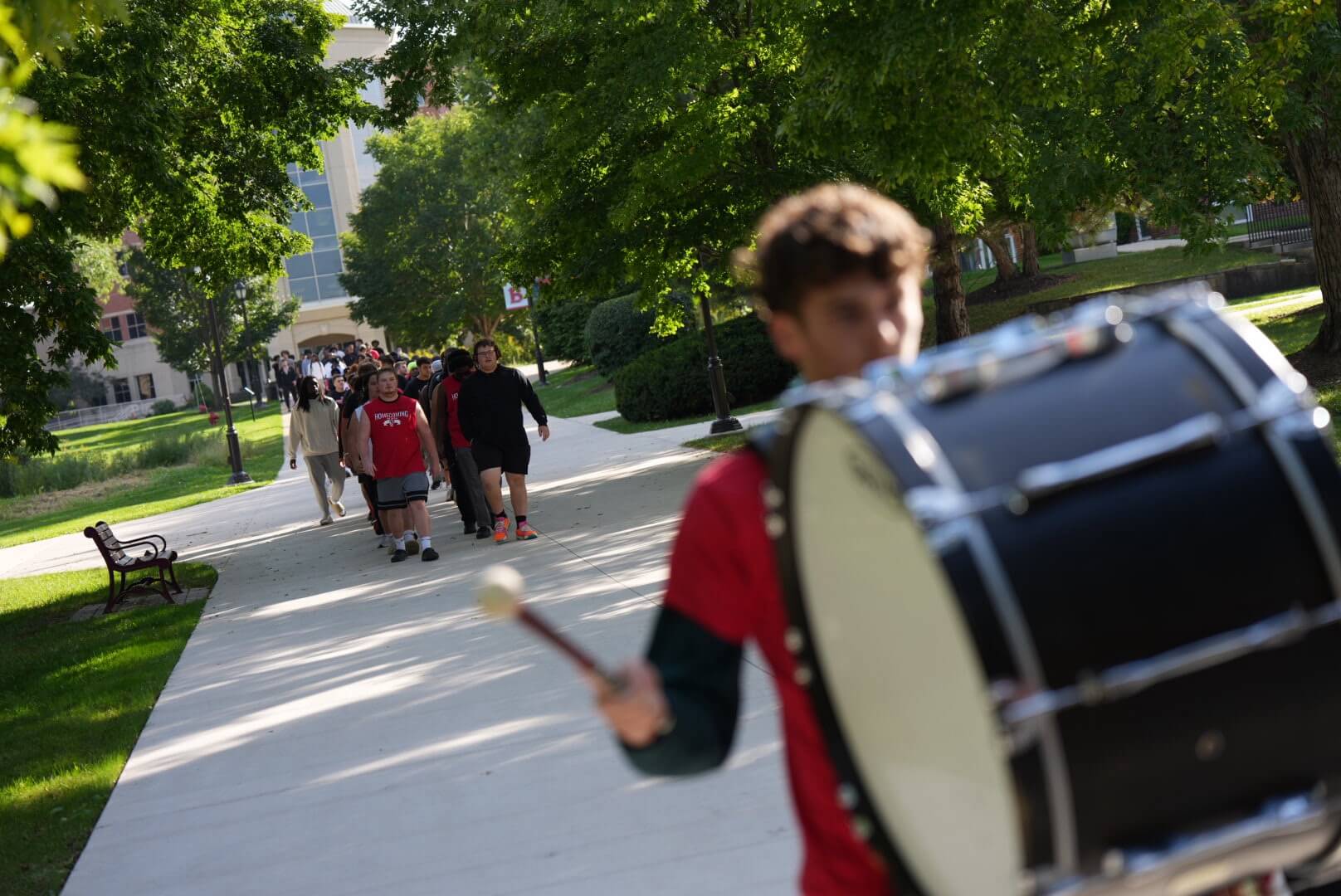 Image of BenU student leading Eagle Walk on campus
