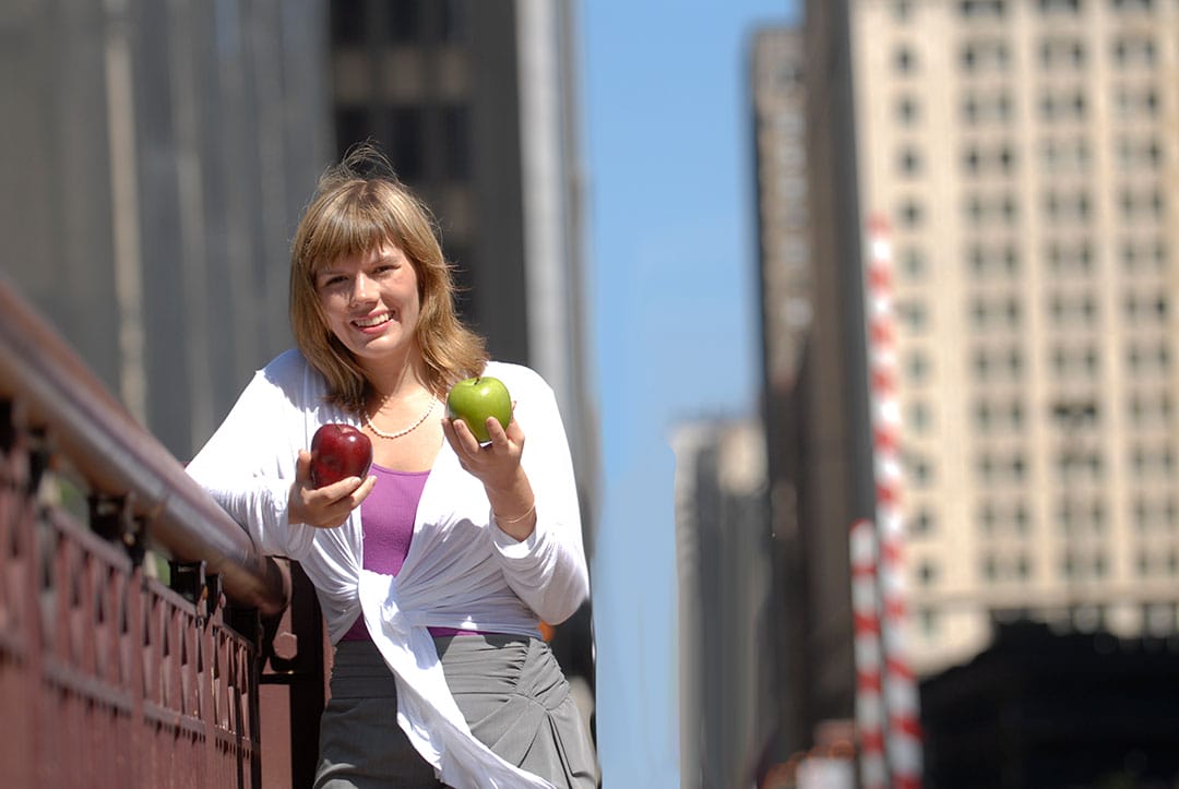 DNPH banner2 alumna holding apples in city photo shoot